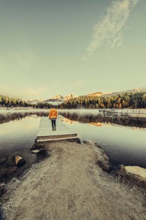 Young woman at Lake Staz near Sankt Moritz in the Engadine in Switzerland. Morning atmosphere with
