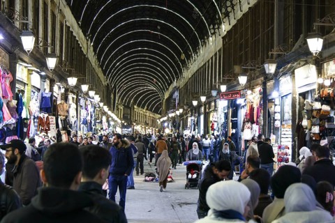 Syrians shop at the historic Al-Hamidiyah Bazaar adjacent to the Umayyad Mosque during the early