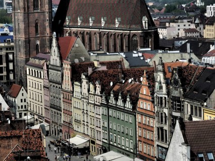 View of the old town of Wroclaw on a series of historic houses with colorful facades and a tall