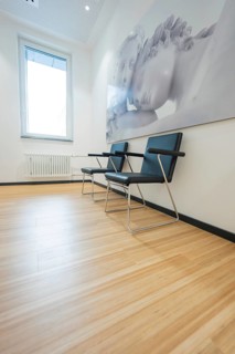 Two modern chairs next to a window with sculptural wall art, radiology in the new health campus,
