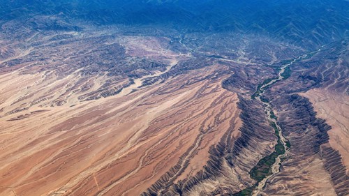 Desert landscape with a winding river and overgrown banks, The landscape and desert near Nasca in