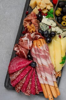 Appetizer, assortment, set, sausage, and cheese, on a wooden board, top view, no people