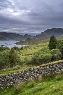 Old dry stone wall and Loch Glencoul near Unapool and Gleann Dubh, Kylesku, Sutherland in the