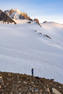 High alpine mountain landscape at sunset, Glacier du Tour, photographer with camera in front of