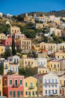 Colourful houses on a hill with clear sky, Symi Town, Symi, Dodecanese, Greek Islands, Greece