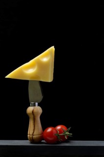 A piece of Swiss Emmental cheese on a cheese knife