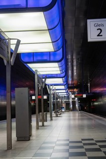 Futuristic underground station with blue lighting and empty tracks, Hafencity University, Hamburg,