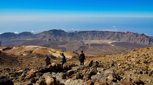 Pico del Teide, summit of Mount Teide, Three people enjoying spectacular views of the mountains,