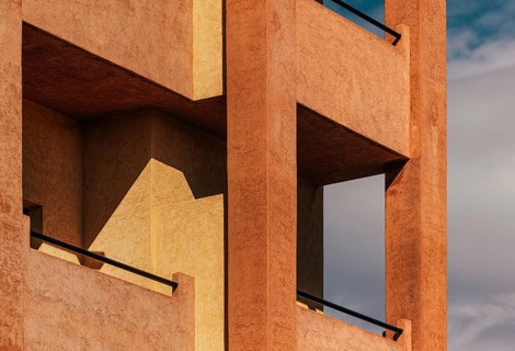 Modern architectural facade featuring geometric patterns and warm, textured surfaces. The play of