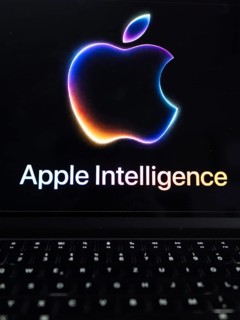 Apple logo in bright neon colours on a Macbook with illuminated keyboard and the text 'Apple