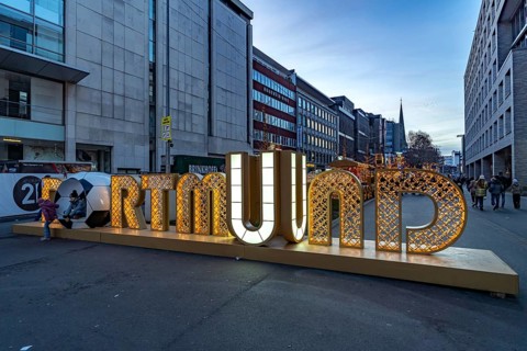 Light installation beer carriage with horses at Dortmund's Christmas market at dusk, Dortmund,