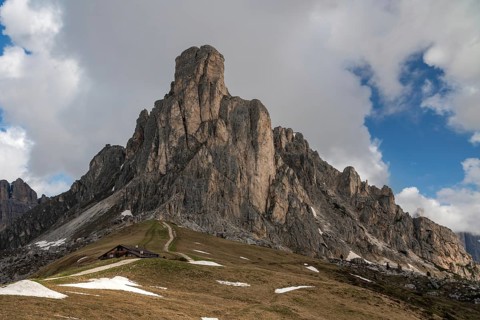 The stunning Passo Giau, located in the Dolomites mountains of Italy, is depicted with dramatic