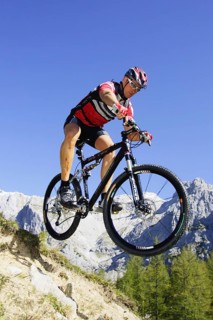 A man on a mountain bike in an alpine landscape