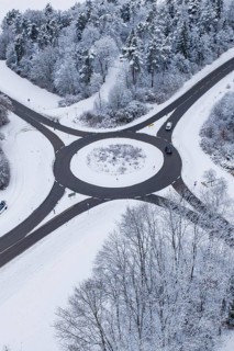 Roundabout, surrounded by snowy trees, from the air, Gechingen, Calw district, Germany