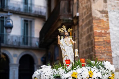 A figure of Jesus is carried through the city centre of Barcelona