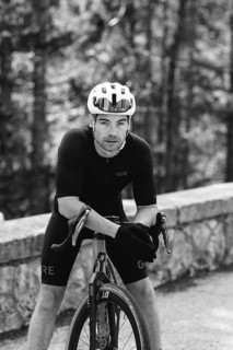 Road bike rider in spring in the Allgäu against the picturesque backdrop of the Alps, Bavaria,