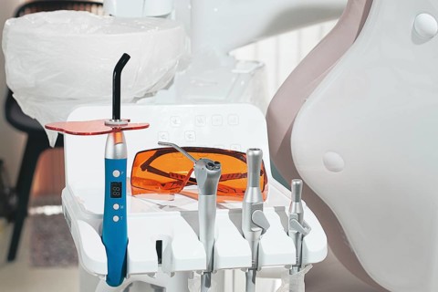 Dental instruments, photopolymer lamp, safety glasses, on a modular table