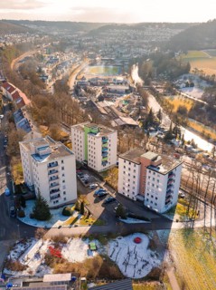 Cityscape with residential buildings and snow-covered hills in winter, Nagold, Black Forest,