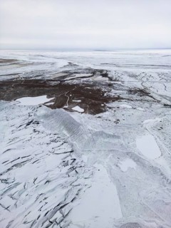 Aerial view of a stunning Icelandic winter landscape captured by drone, showcasing snow-covered