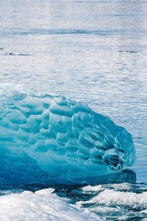 Close-up of vibrant blue ice formations at Diamond Beach, Iceland. The intricate textures and