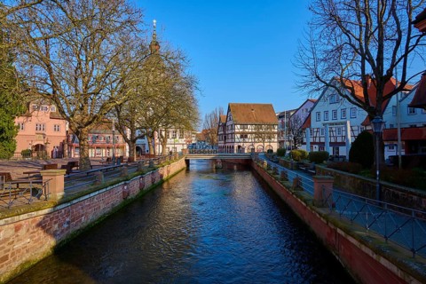 Mümling river, flows under a bridge in an old town with half-timbered houses, Erbach, Odenwald,