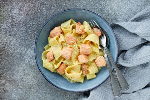 Papardelle pasta, in creamy sauce with salmon, natural light, lifestyle, homemade, on a gray