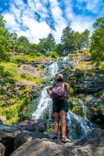 A hiker in summer at the Todtnau waterfall in the Black Forest in Germany