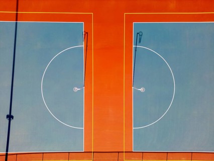 Top view capturing the vibrant, perfectly aligned netball courts in Canberra. The aerial