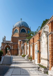Graves on a wall, behind the dome of St Christopher's Church, San Michele cemetery island, Venice,