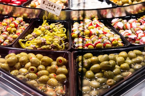 Olive and pepperoni skewers at a market stall at the Mercat de la Boqueria, famous market on the