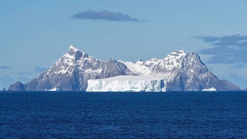 Table iceberg off a snow-covered mountain range in the South Atlantic, coast of South Georgia,