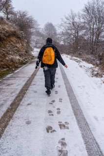 A young man enjoying himself on the snowy road of gipuzkoa's mount aizkorri. Snowy landscape by