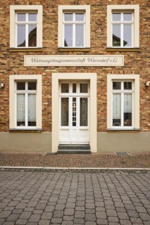 Historic brick building of Wohnungsbaugenossenschaft Warendorf e.G. in Warendorf, district of