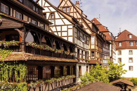 Picturesque view of traditional half timbered buildings adorned with flower boxes, showcasing the