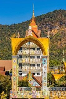 Bell tower decorated with mosaic and glass works of art, Buddhist temple complex Wat Phra That Sorn