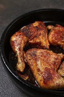 Baked chicken legs, with crispy skin, served in a pan, rustic style, homemade, no people