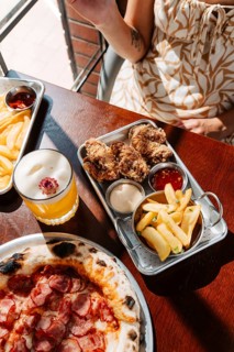 A flavorful spread featuring crispy fried chicken, potato dippers with assorted sauces, and