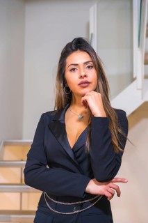 Lifestyle, portrait of brunette Caucasian girl in a black elegant suit posed on the stairs of a