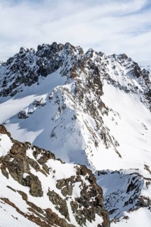 View at the summit of Piz Grialetsch in winter, with summit of Piz Vadret with snow, Grisons Haute