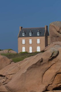 Old house next to Lighthouse Mean Ruz at Ploumanach, Cotes d'Armor in the evening light
