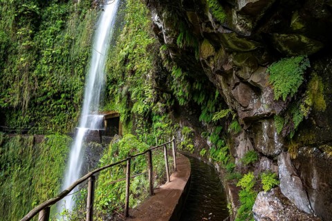 Path along the levada in the gorge of the Ribeira da Janela, below a rocky outcrop with wild