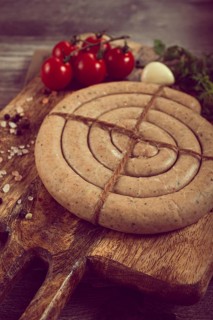 Raw spiral sausages, on a wooden board, top view, no people
