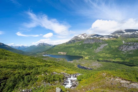 View of Innerdalen high valley with mountain landscape and lake Innerdalsvatna, waterfall on the