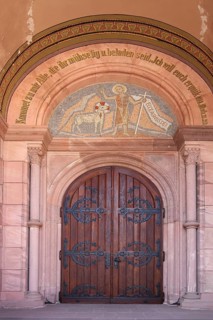 Portal of the neo-Romanesque church of St John the Baptist with biblical quotation: Come unto me,
