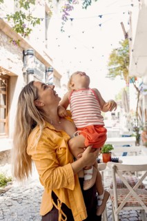 A joyful moment between a mother and her daughter as they enjoy a beautiful day outside. The mother