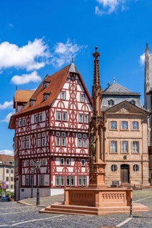 Abbey fountain, reconstructed half-timbered building of the Löwenapotheke and historic