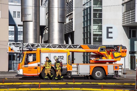 Fire service at Stuttgart Hospital. Fire trucks are parked in front of the building following a