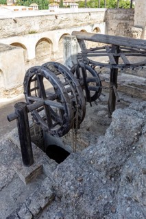 Old wooden machinery with wheels in an antique stone structure, Jerez