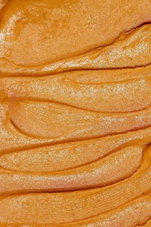 A close-up image showcasing the smooth, creamy texture of freshly spread peanut butter with