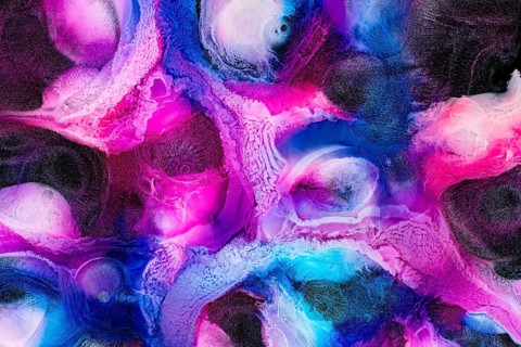 An abstract texture featuring vibrant pink and blue hues. The intricate patterns and swirling